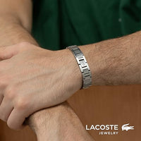 Lacoste bracelet with toggle clasp, METROPOLE collection. Decorated with a petit piqué pattern - Available for him and her. 