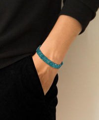 Lacoste bracelet with toggle clasp, METROPOLE collection. Decorated with a petit piqué pattern - Available for him and her. 